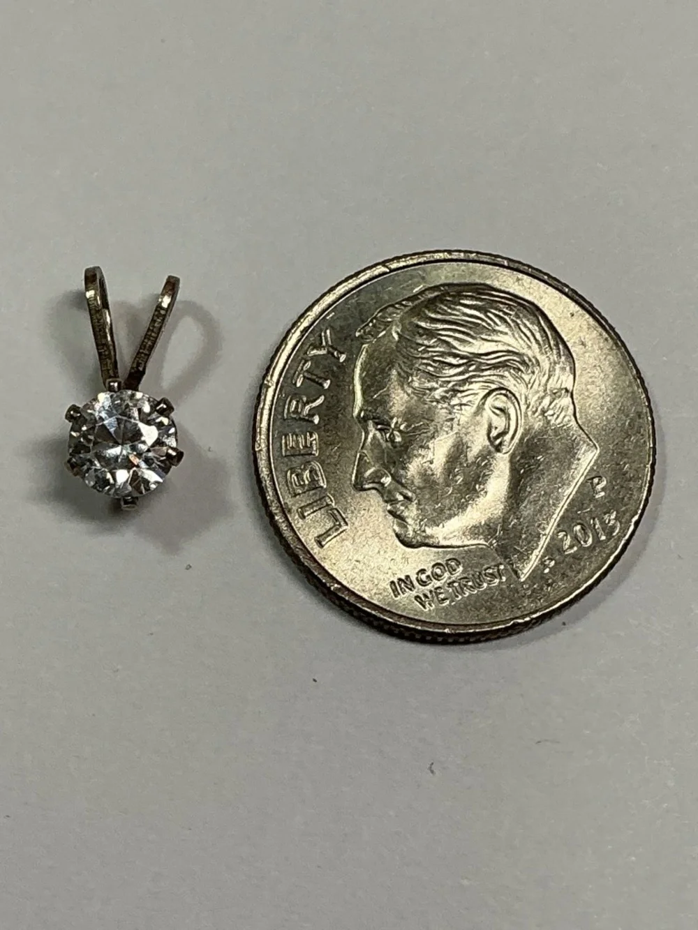 Sterling Silver Petite Pendant with a clear stone. 1/2 inches long